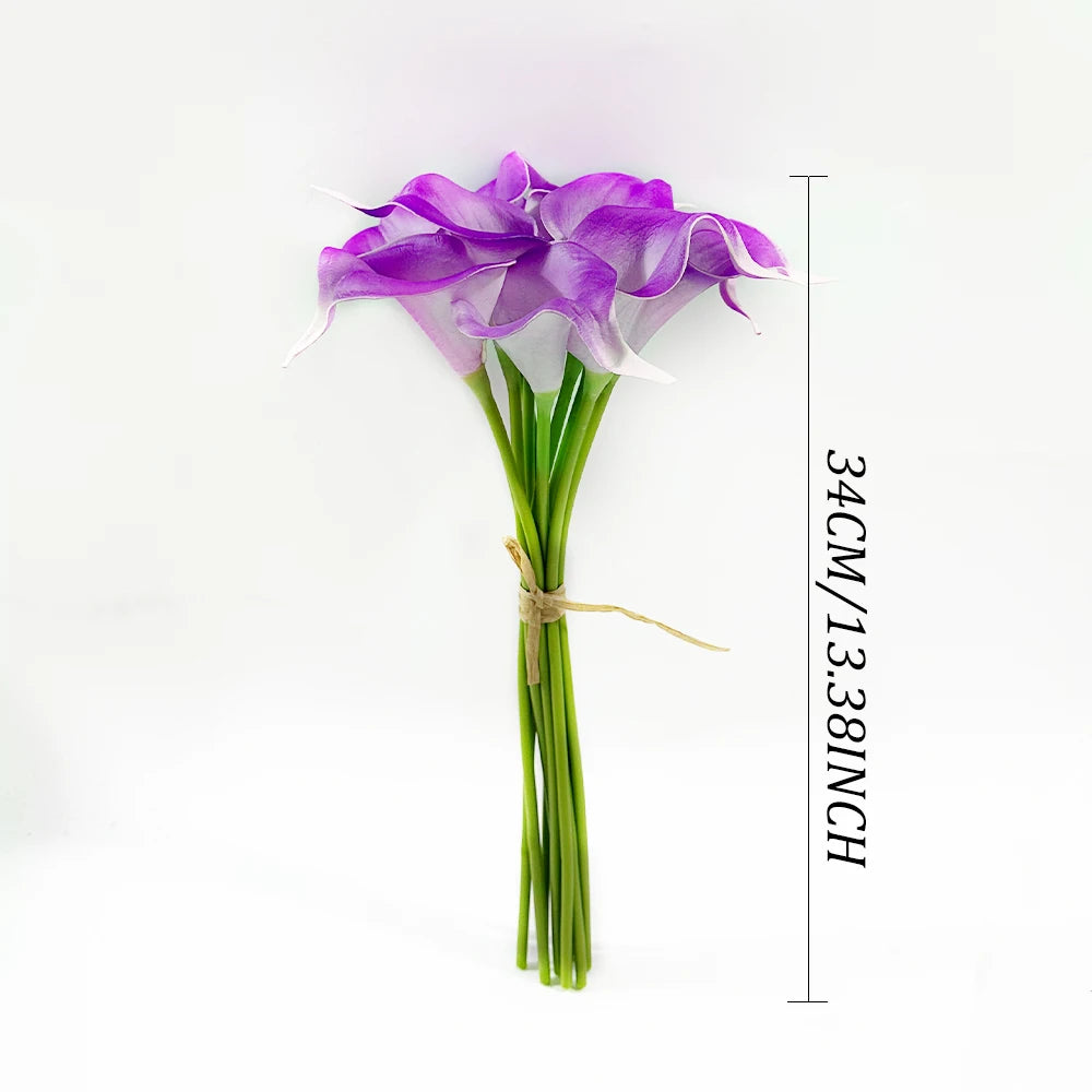 A bouquet of six artificial purple calla lilies with green stems shown against a white background.