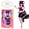 A detailed ball-jointed doll with elaborate makeup and a purple and black dress is shown next to its packaging.