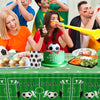 A group of people celebrating a birthday with soccer themes, including a cake and various party supplies on a green table.