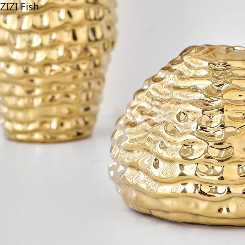 A close-up of a golden wrinkle ceramic tabletop vase with textured, undulating lines.
