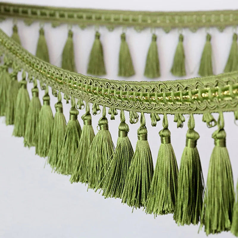 Green decorative tassel fringe trim with gold accents for curtains and DIY projects