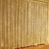 White sheer curtain illuminated by warm LED string lights creating a sparkling backdrop