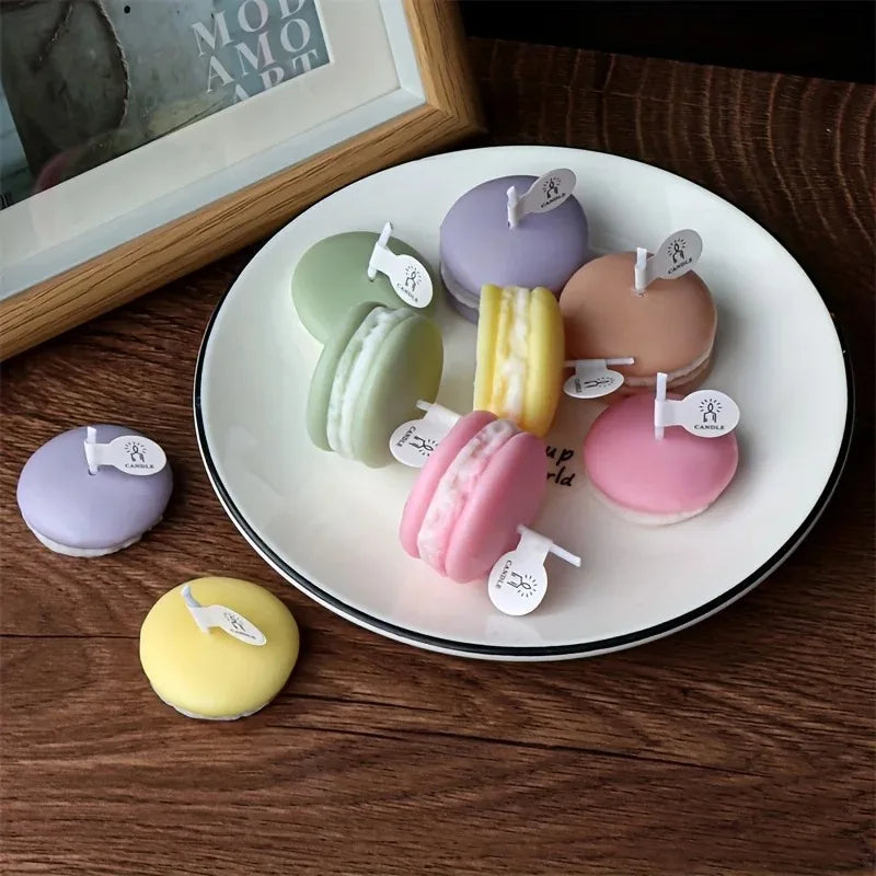 A collection of pastel-colored macaron-shaped soy wax candles arranged on a white plate.