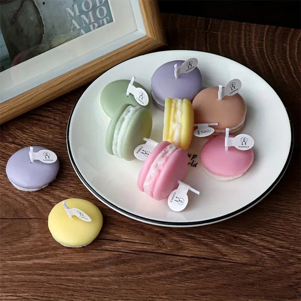 A collection of pastel-colored macaron-shaped soy wax candles arranged on a white plate.