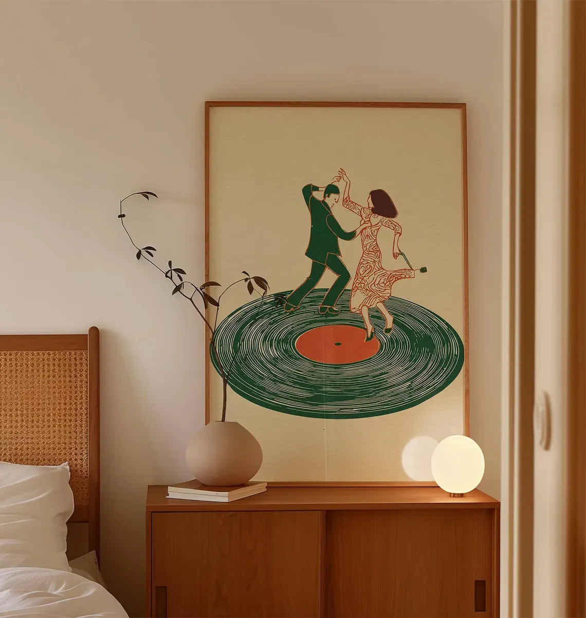 A canvas print featuring a stylized illustration of a couple dancing on a vinyl record, framed in wood.