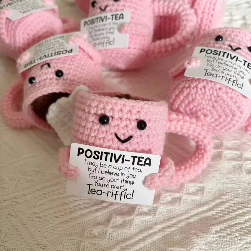 Pink crocheted tea cup ornament with a motivational charm featuring the text POSITIVI-TEA