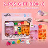Two gift boxes containing coconut cream and salted caramel products with various themed decorations.
