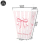 A set of 12 pink striped paper cups decorated with bows for birthday or bridal shower use.