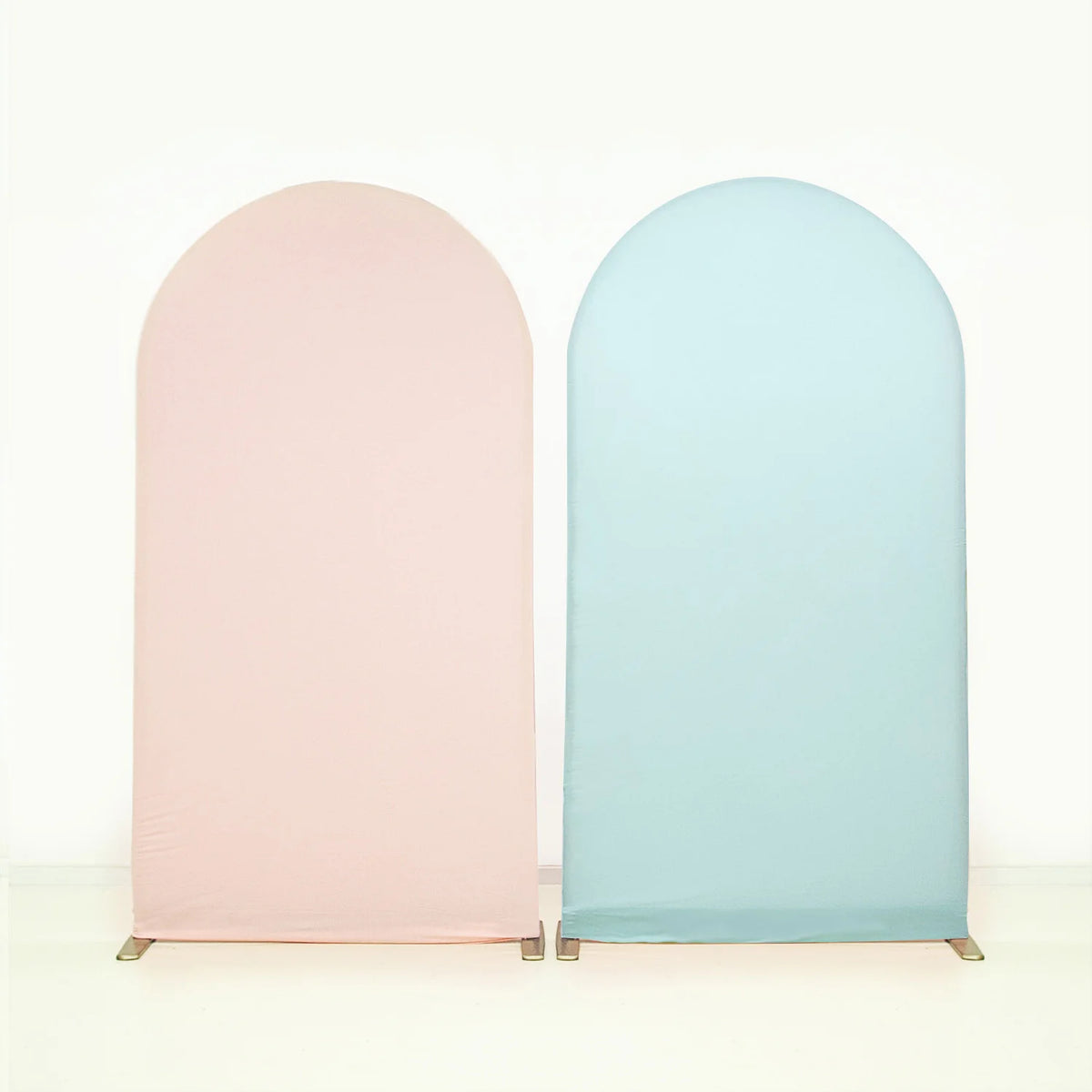 Two fabric arch backdrop covers in soft pink and light blue.