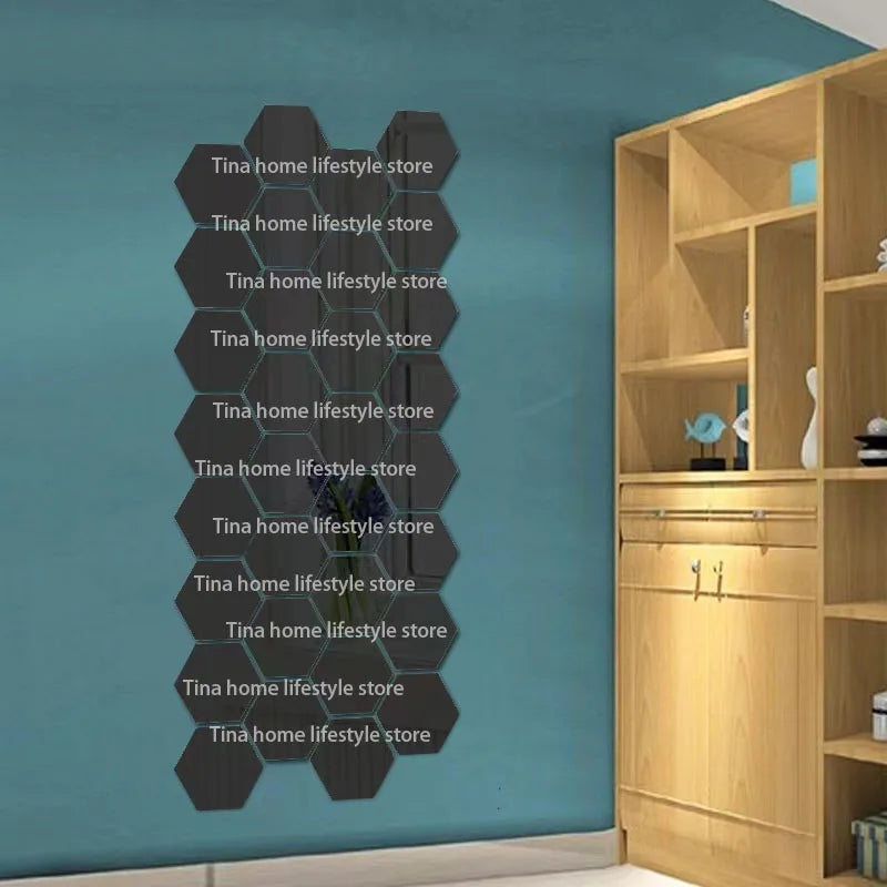 A display of 12 self-adhesive hexagon mirror wall decor stickers in black against a teal wall, next to a wooden cabinet.