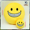 A yellow plush doll shaped like a smiling face with a wide, toothy grin.