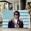 A woman models a flag tapestry featuring the American flag design with blue and white stripes and stars.