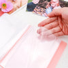 Clear A6 storage album with 40 pages for stickers, photos, and craft supplies shown open on a white surface.