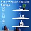 A set of three white corner mounting shelves displayed on a blue wall, featuring various decorative items.