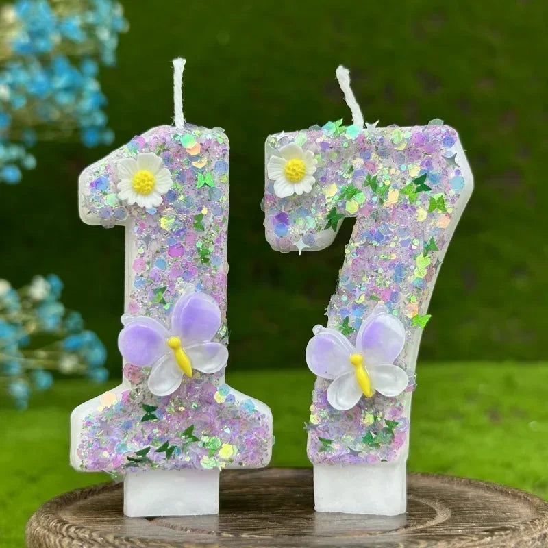 Two number cake candles shaped like 1 and 7 decorated with purple flowers and butterflies