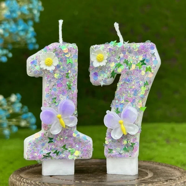 Two number cake candles shaped like 1 and 7 decorated with purple flowers and butterflies