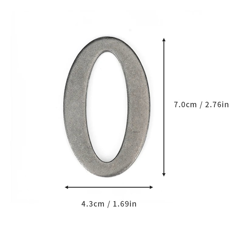 A silver magnetic house number shaped like the numeral zero, measuring 7.0cm (2.76in) by 4.3cm (1.69in).