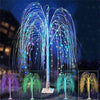 A weeping willow tree light display with multicolored LED lights showering down against a dark blue background.