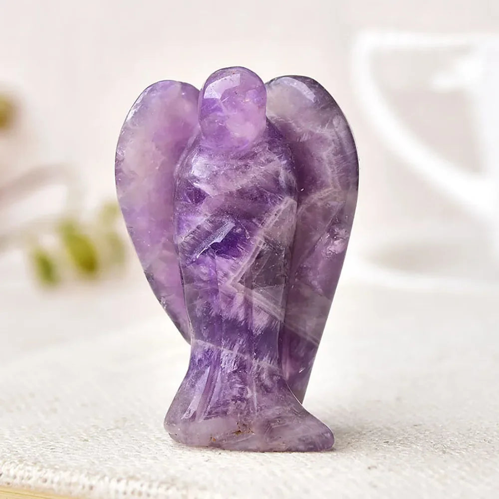 Hand-carved amethyst angel crystal figurine with purple translucent facets