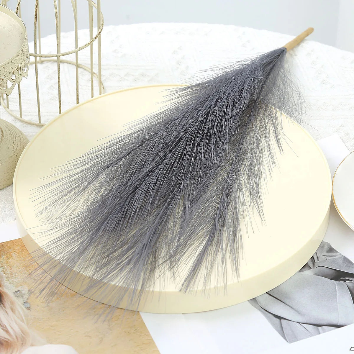 A bundle of gray artificial pampas grass used as boho home decor