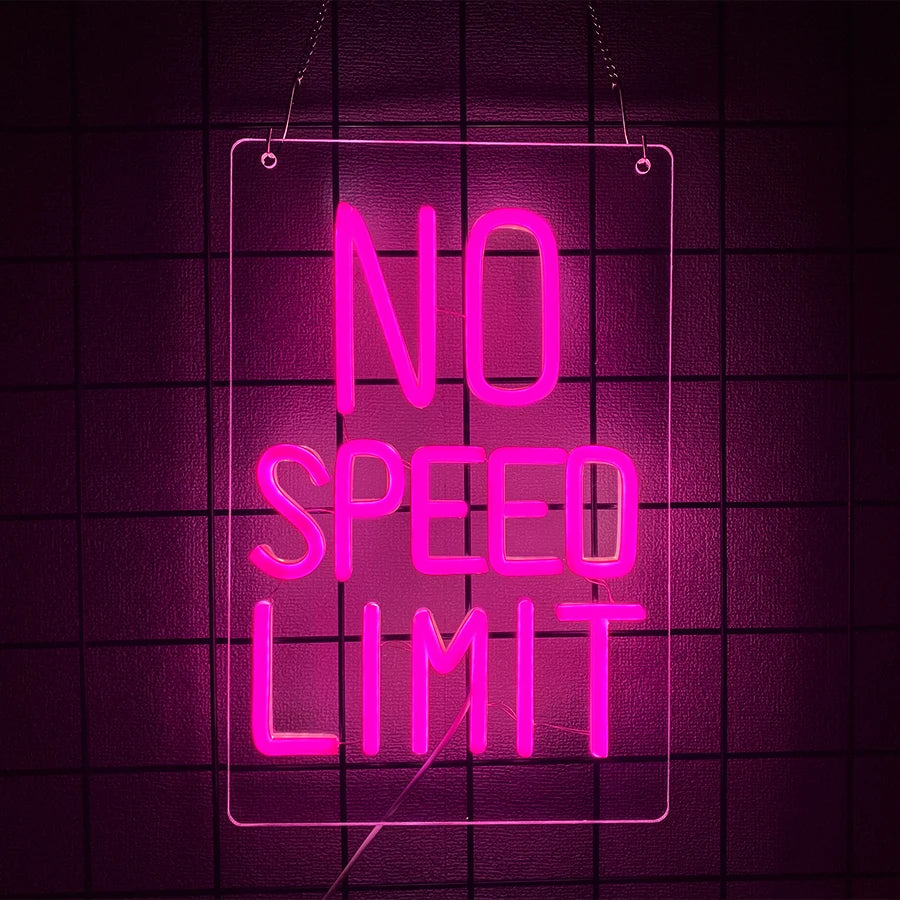 A neon pink sign hangs against a dark grid background displaying the text NO SPEED LIMIT.
