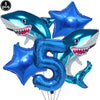 A set of blue shark foil balloons, including a number 5, for an ocean-themed party decoration.