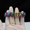 A hand wearing a natural wooden rosary bracelet with Virgin Mary and Jesus charms.