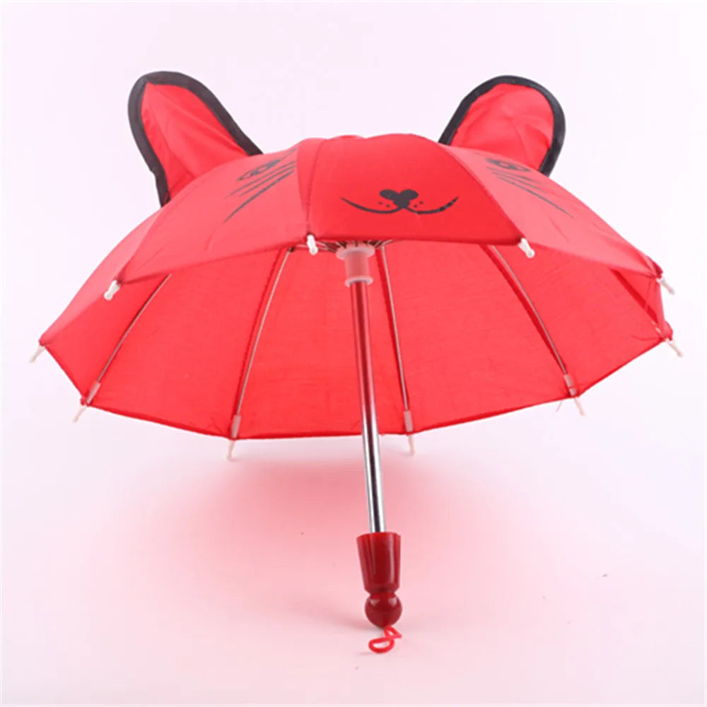 A red and black cat-themed parasol or umbrella for dolls.