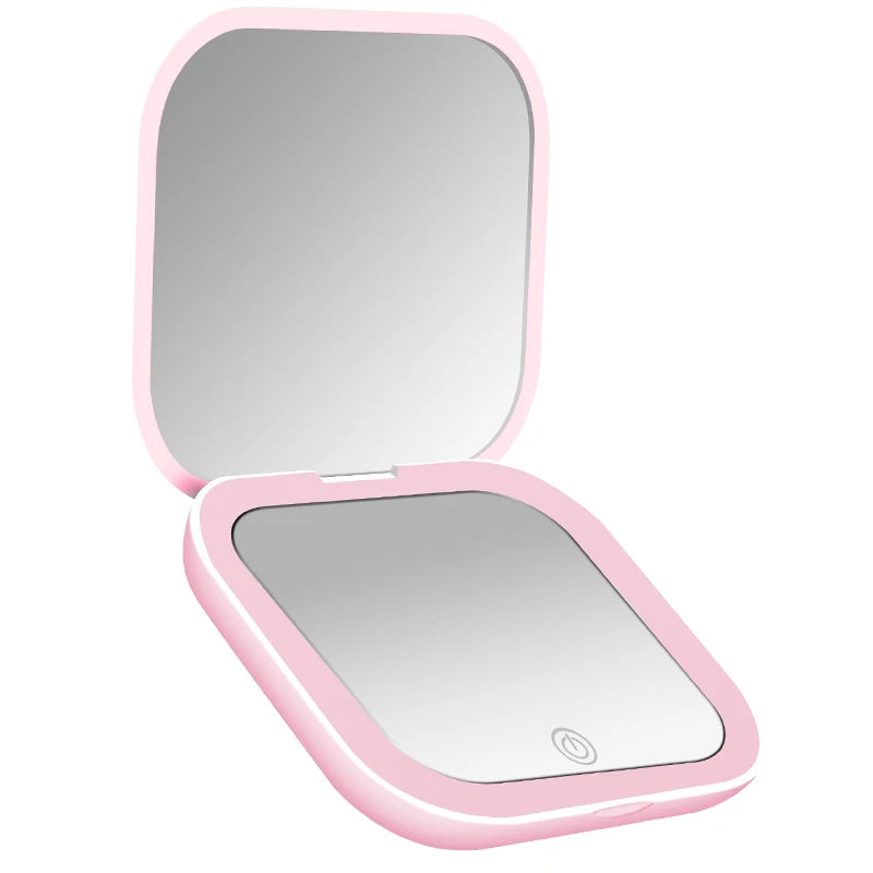 A pink portable folding makeup mirror with an LED light, shown open.
