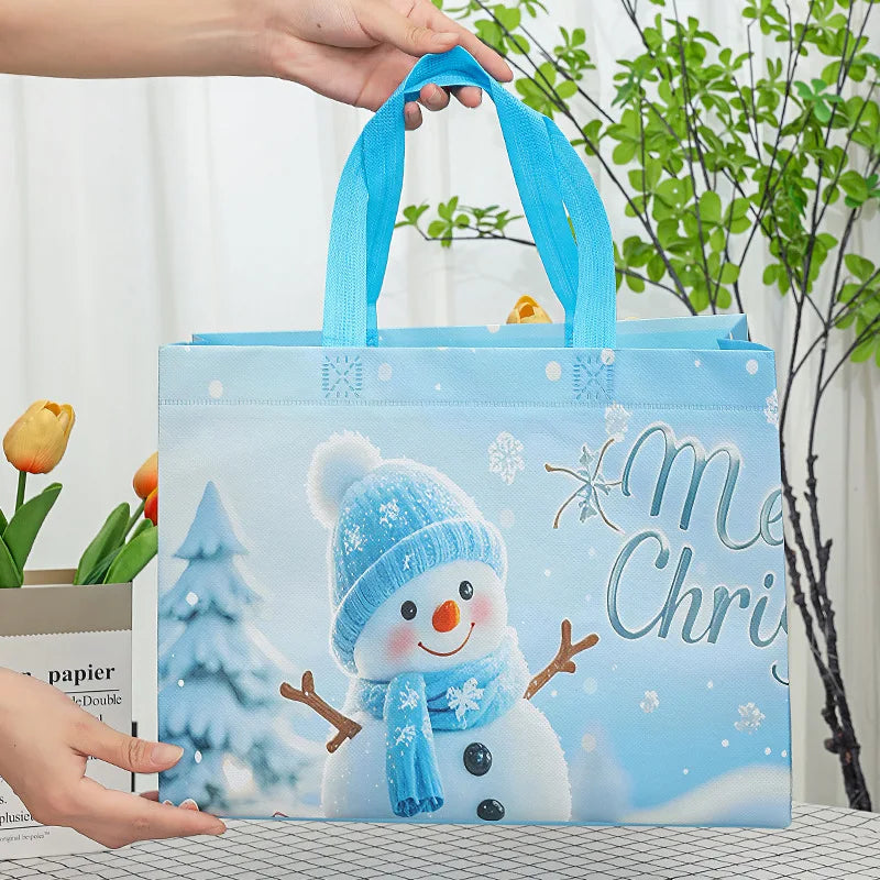 A light blue reusable non-woven Christmas gift bag featuring a cute snowman design and snowflake accents.