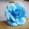 A light blue silk foam rose flower with layered petals displayed on a wooden surface.