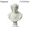A white plaster bust miniature of a classical Greek figure with curly hair and draped clothing.