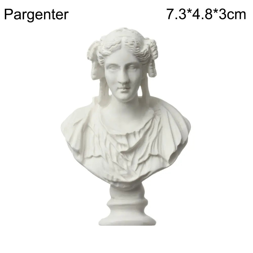 A white plaster bust miniature of a classical Greek figure with curly hair and draped clothing.