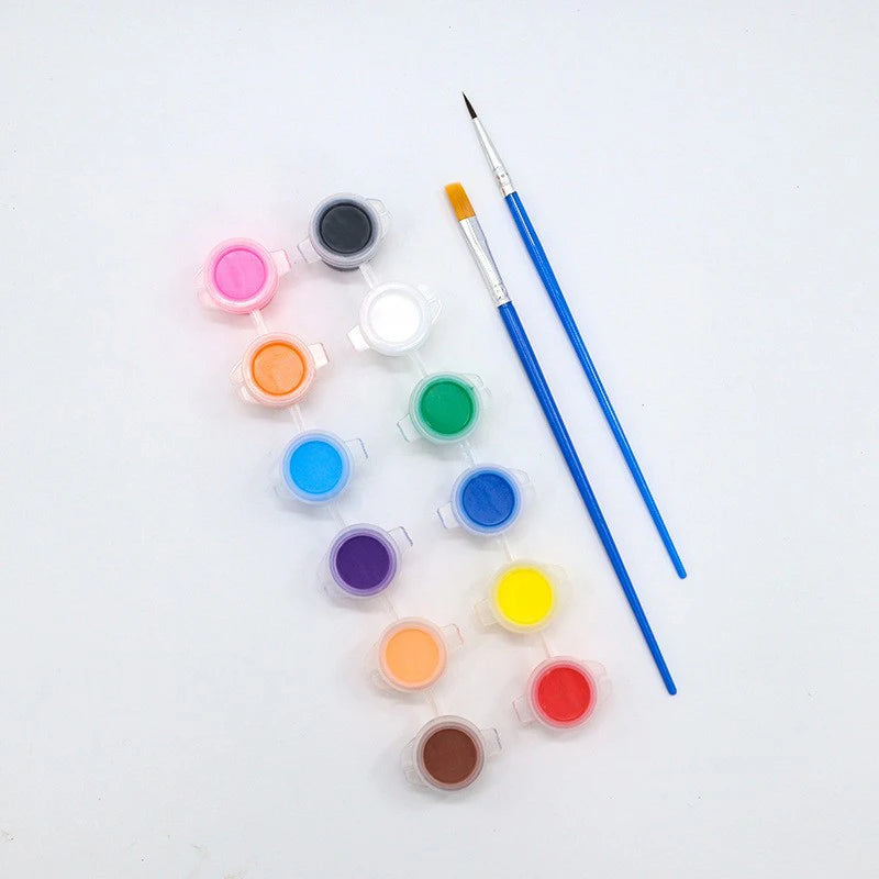 A set of paintable craft masks and a fine paintbrush laid out on a white surface.