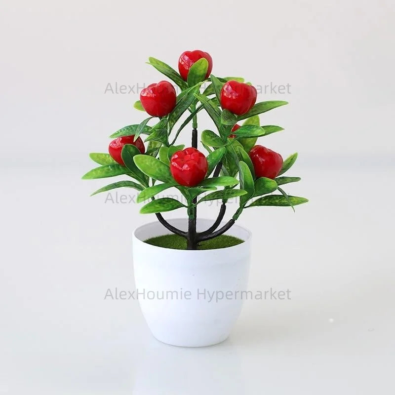 Artificial lemon tree bonsai with bright red fruit on a green branch planted in a white pot