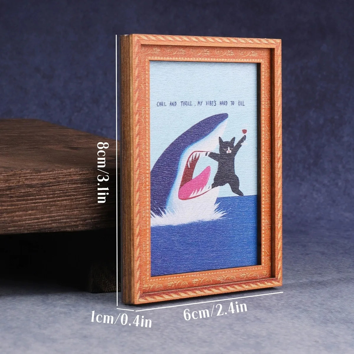 A wooden photo frame displaying a watercolor-style cat portrait on blue and purple background.