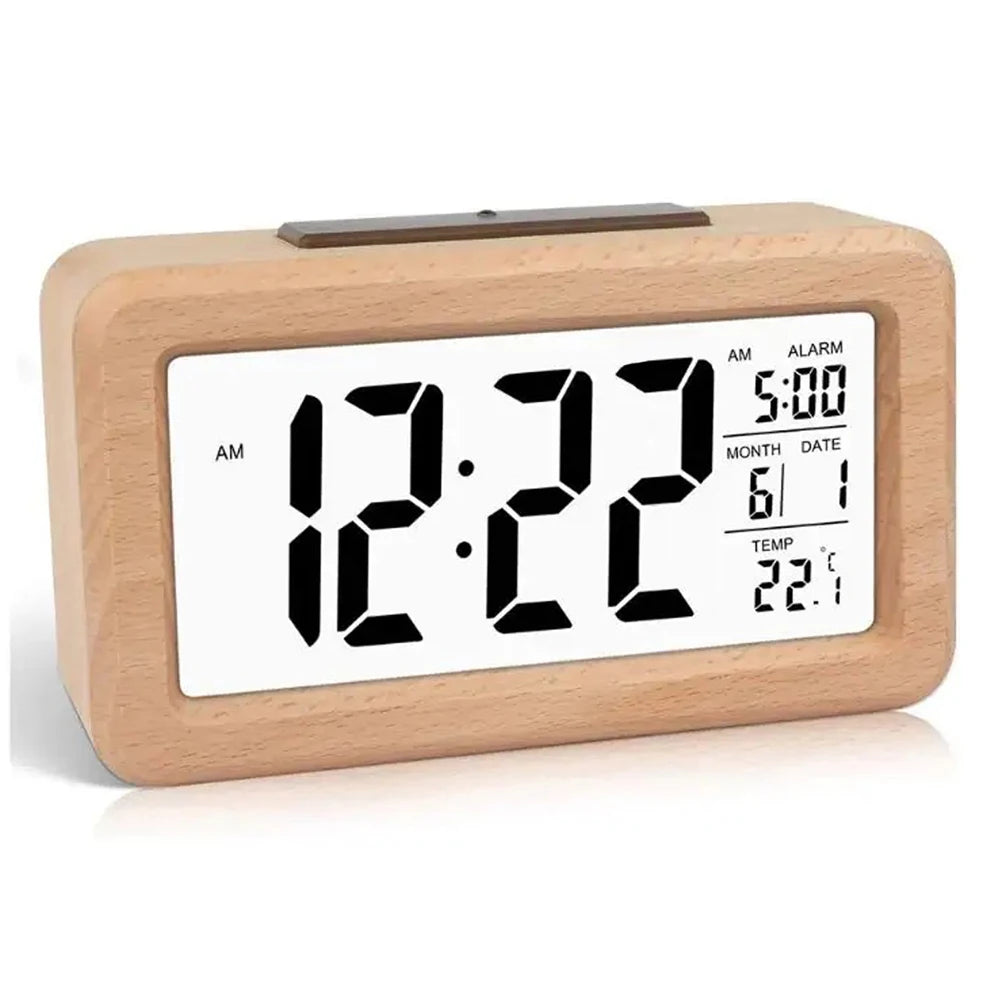 A light wood digital alarm clock displaying the time 12:22, AM, with a calendar date and temperature reading.