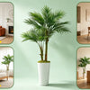 A tall artificial areca palm tree in a white pot displayed in a modern interior setting.