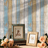 Vintage blue and white plank wallpaper featuring distressed wood texture on a wall.