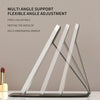 A clear acrylic multi-angle support flexible angle adjustment vanity mirror with a makeup brush resting on it.