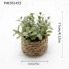 A small artificial potted plant with green leaves in a natural woven pot.
