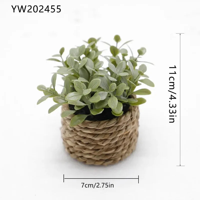 A small artificial potted plant with green leaves in a natural woven pot.
