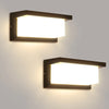 A modern rectangular LED wall sconce with a white light emitting from a dark finish mounted on a wall.