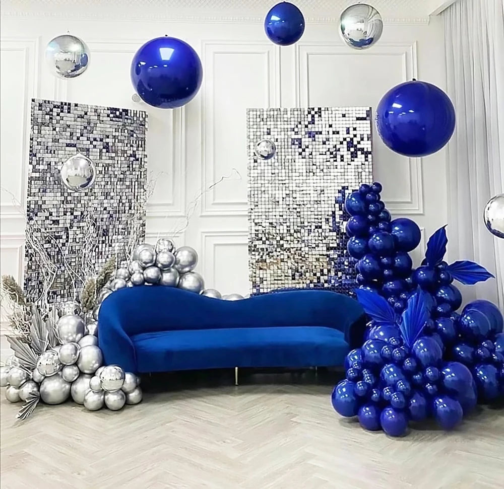 A luxurious interior decorated with blue and silver latex balloons, including large spherical balloons and clusters of round 