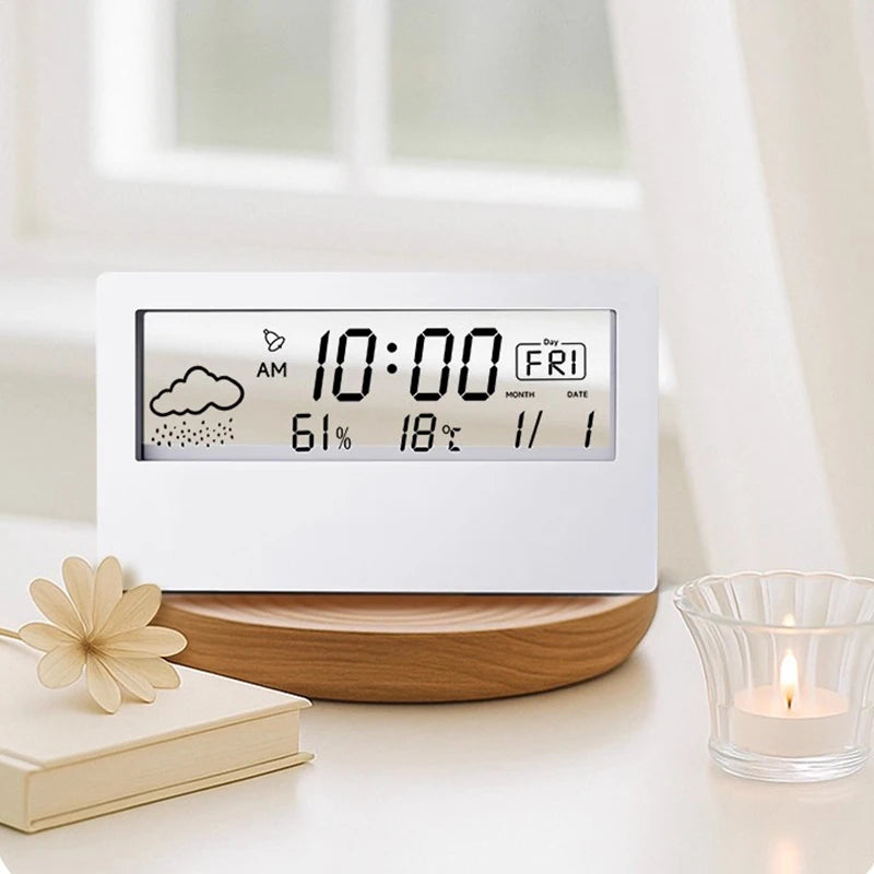 A white LED digital thermometer and hygrometer displays the time 10:00 AM, weather icons, humidity, temperature, and date.