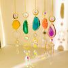 A collection of hanging crystal decor featuring various colored agate stones and gold findings.