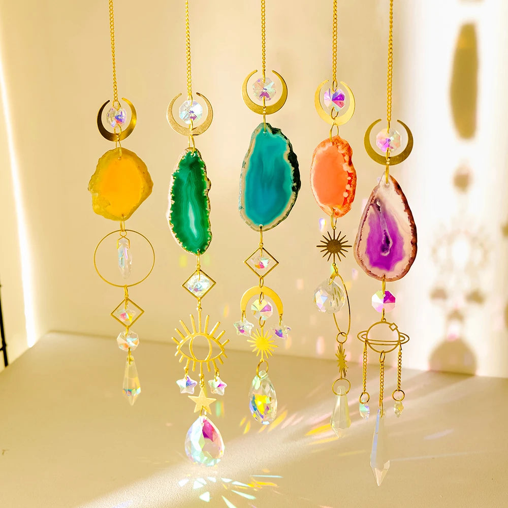 A collection of hanging crystal decor featuring various colored agate stones and gold findings.