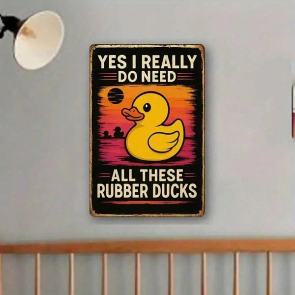 A black wooden wall sign with yellow rubber duck illustration and text that reads Yes I really do need all these rubber ducks