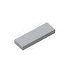 A rectangular smooth building brick tile in a light gray color.