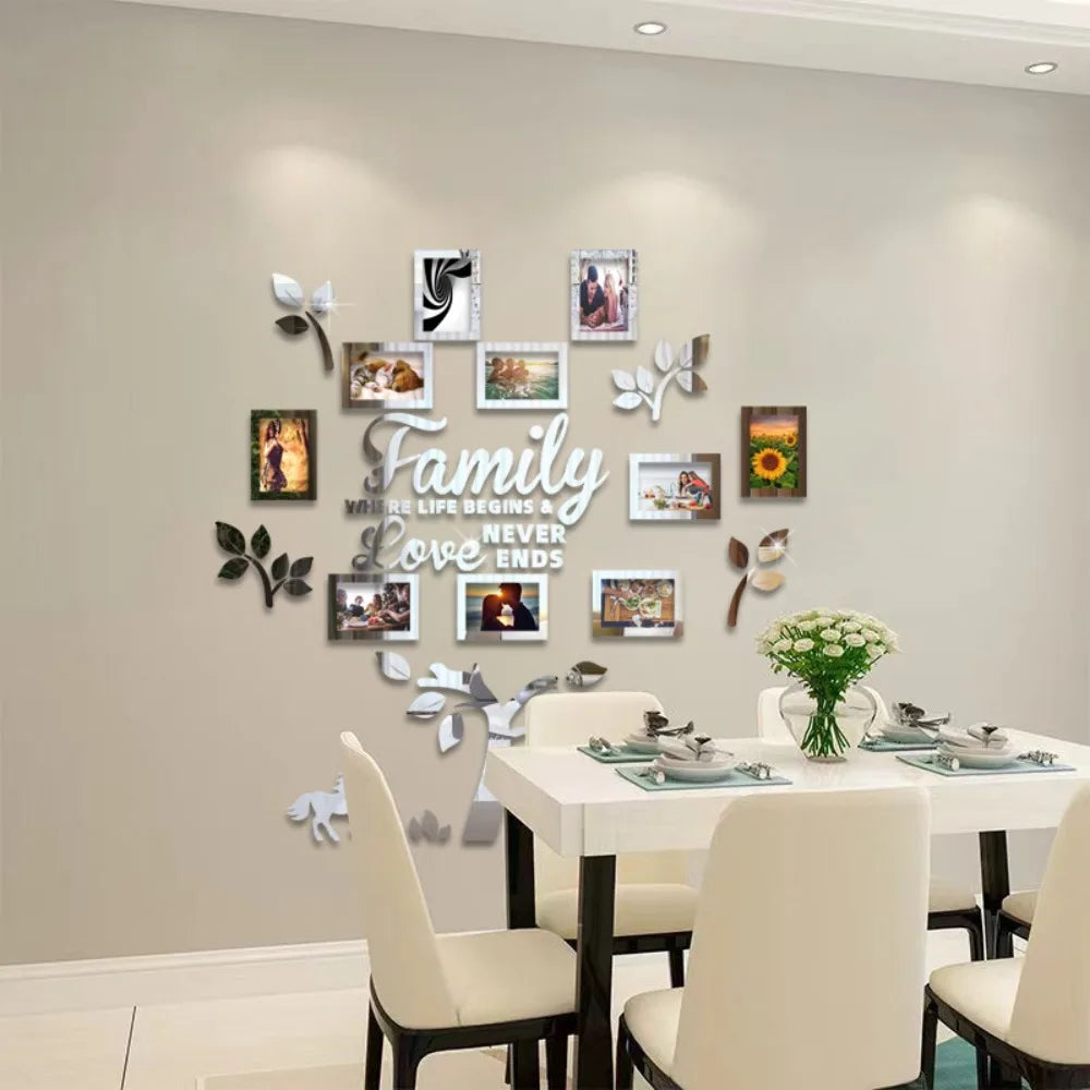 A wall collage featuring framed photos and leaves arranged in the shape of a family tree for a decorative display.